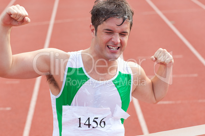 Ecstatic sprinter showing expression of victory in front of the