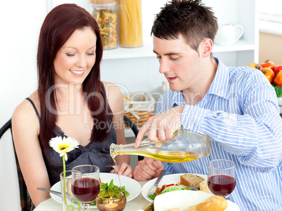 Young couple having dinner in the kitchen