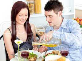 Young couple having dinner in the kitchen