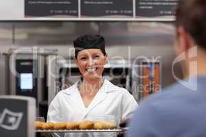 young baker with baguettes