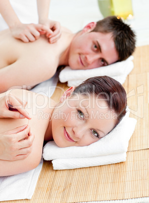 Charming caucasian couple receiving a back massage