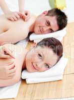 Charming caucasian couple receiving a back massage