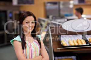 Charismatic female cook smiling at the camera
