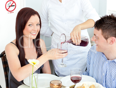 Joyful young couple having dinner at the restaurant
