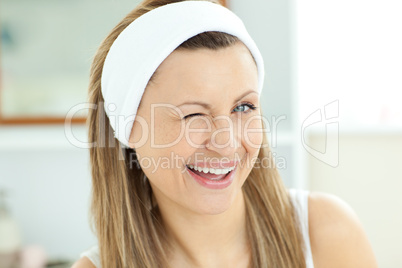 Cheerful woman smiling at the camera in the bathroom