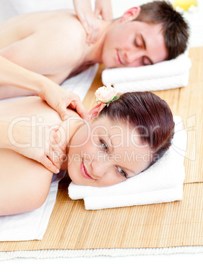 Relaxed caucasian couple receiving a back massage