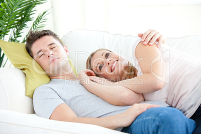 Portrait of a loving couple sitting on a sofa in the living-room