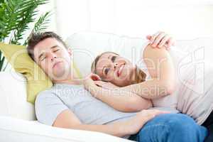 Portrait of a loving couple sitting on a sofa in the living-room