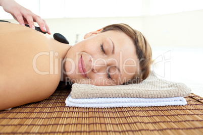 Portrait of a beautiful woman lying on a massage table with hot