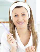 Positive woman filling her nails in the bathroom