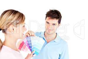 Bright young couple choosing color for a room