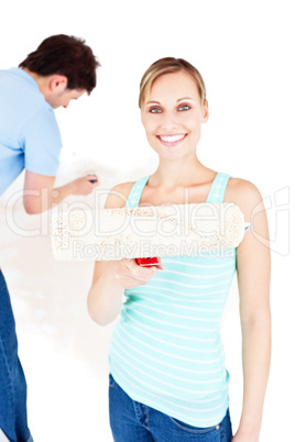 Beautiful couple painting a room