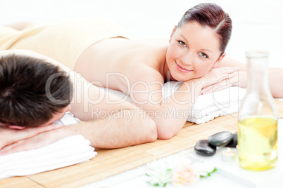 Attractive young couple lying on a massage table
