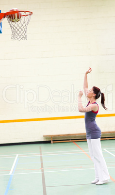 Gifted woman practicing basketball