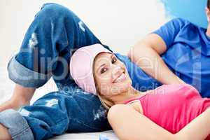 Delighted couple relaxing after painting a room