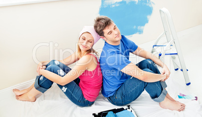 Relaxing couple relaxing after painting a room