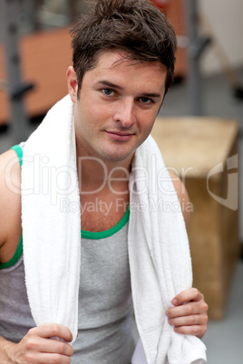 Handsome athletic man standing with a towel