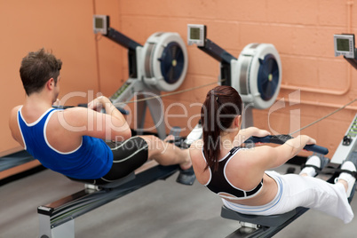 Concentrated people using a rower
