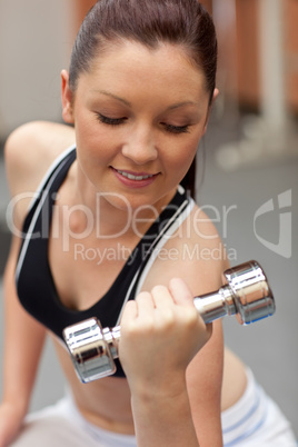 Portrait of a beautiful woman working out with dumbbells