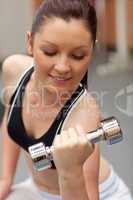 Portrait of a beautiful woman working out with dumbbells