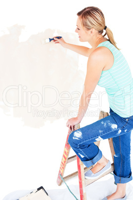 Animated young woman painting a room