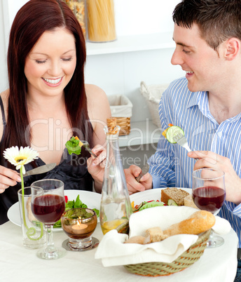 Young caucasian couple having dinner at home