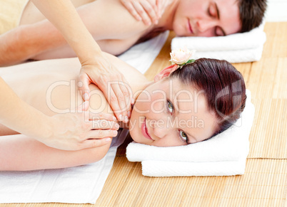 Bright young couple receiving a back massage