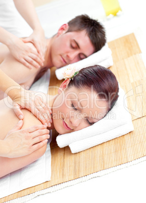 Attractive young couple receiving a back massage