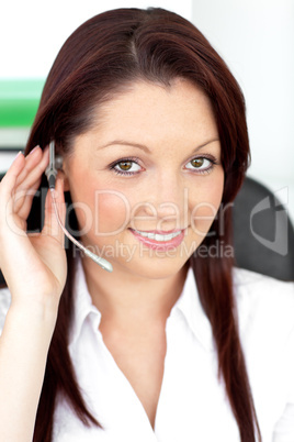 Attractive young businesswoman wearing earpiece in a customer se