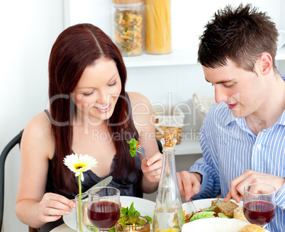 Affectionate caucasian couple having dinner at home