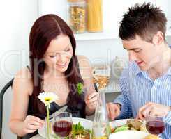 Affectionate caucasian couple having dinner at home