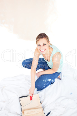 Smiling woman painting a room