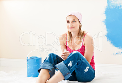 Serious young woman sitting at the middle of the room she is pai