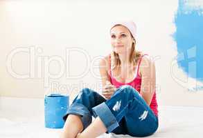 Serious young woman sitting at the middle of the room she is pai