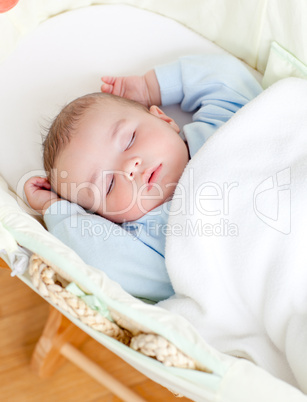 Adorable baby sleeping in his bed