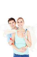 Affectionate caucasian couple painting a room