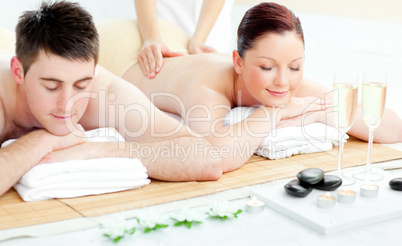 Charming young couple enjoying a back massage