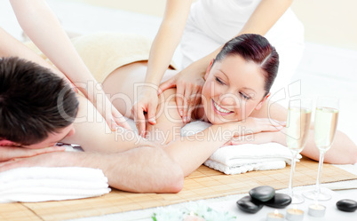 Positive young couple enjoying a back massage