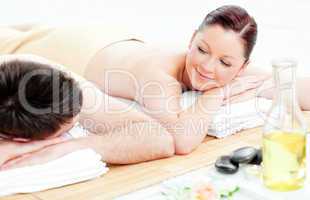 Adorable young couple lying on a massage table