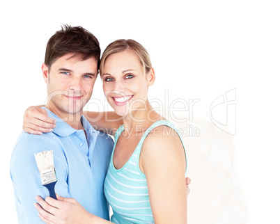 Happy young couple painting a room