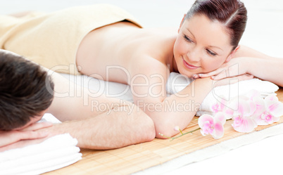 Loving young couple lying on a massage table