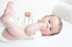 Adorable baby lying on the back in the living-room