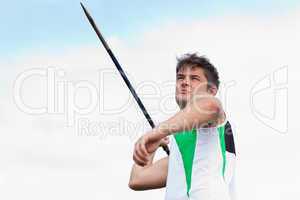 Determined sportsman throwing the javelin