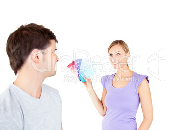 Young caucasian couple choosing color for a room