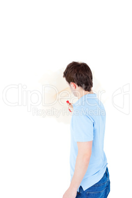 Handsome young man painting a room