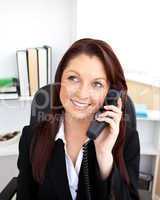 Attractive businesswoman talking on phone sitting