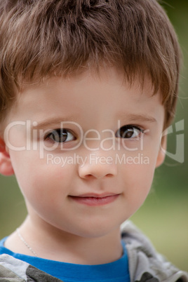 Portrait of cute boy in the nature