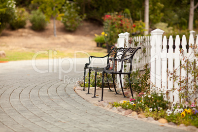 Iron Park Bench near a White Picket Fence