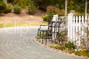 Iron Park Bench near a White Picket Fence