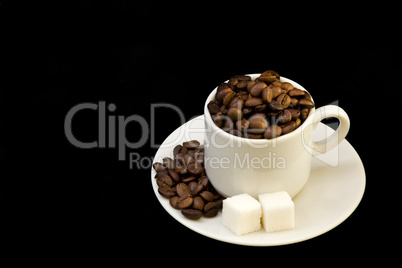 white cup with coffee beans and shugar